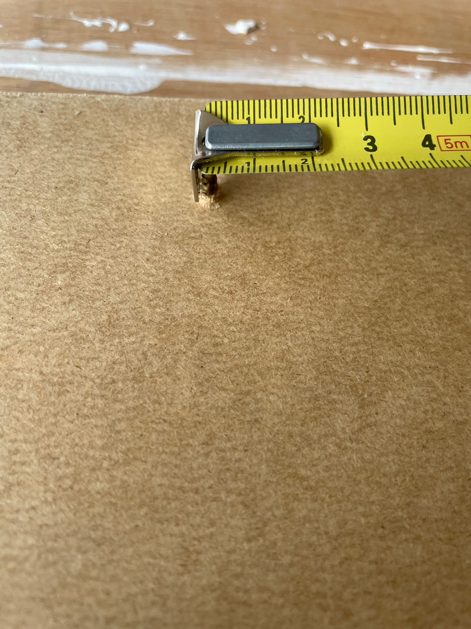 Tape measure hooked onto a screw